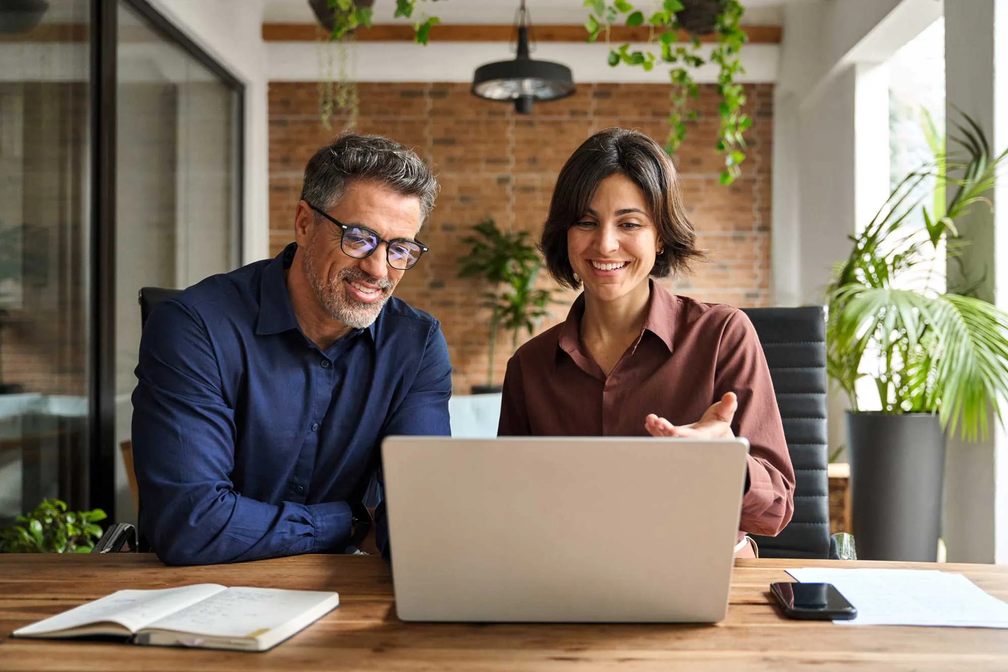 Two professional people working together on business finances analysis